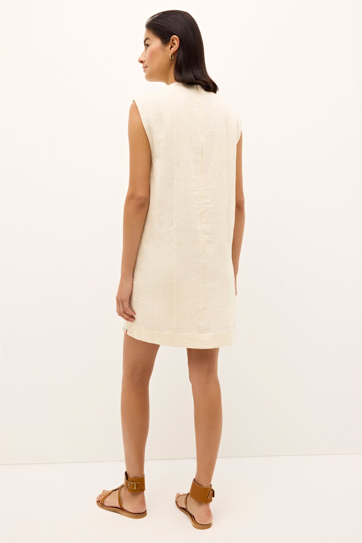 Playful ivory shift dress with red, green, and lavender embroidery details 