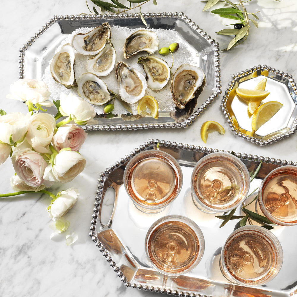 Top view of Pearled Small Rectangular Octagonal Tray showcasing hand-sculpted pearled frame and polished surface on a marble tabletop with oysters, lemon wedges, and glasses