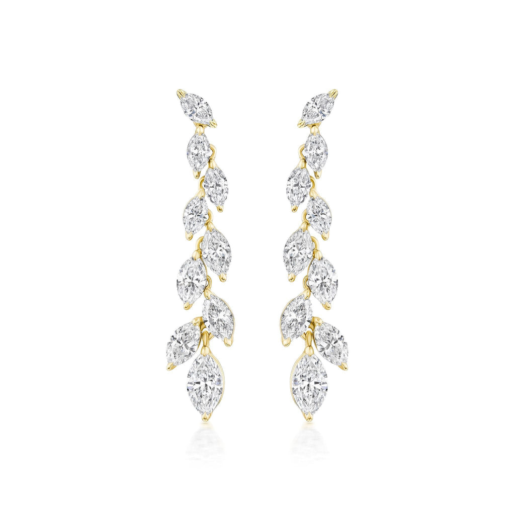 The Marquise Diamond Waterfall Drop Earrings showcase a vertical row of marquise cut diamonds in a leafy, vine-inspired gold design for a delicate, sparkling look.