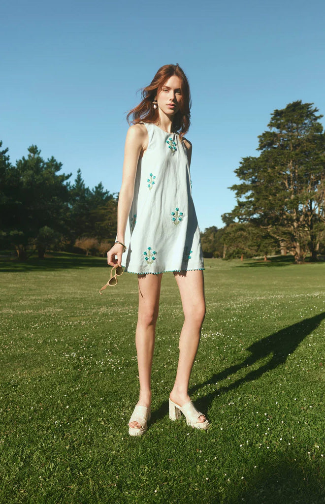 Front view of Mattie Dress showcasing turquoise beadwork and beaded hem on model outdoors