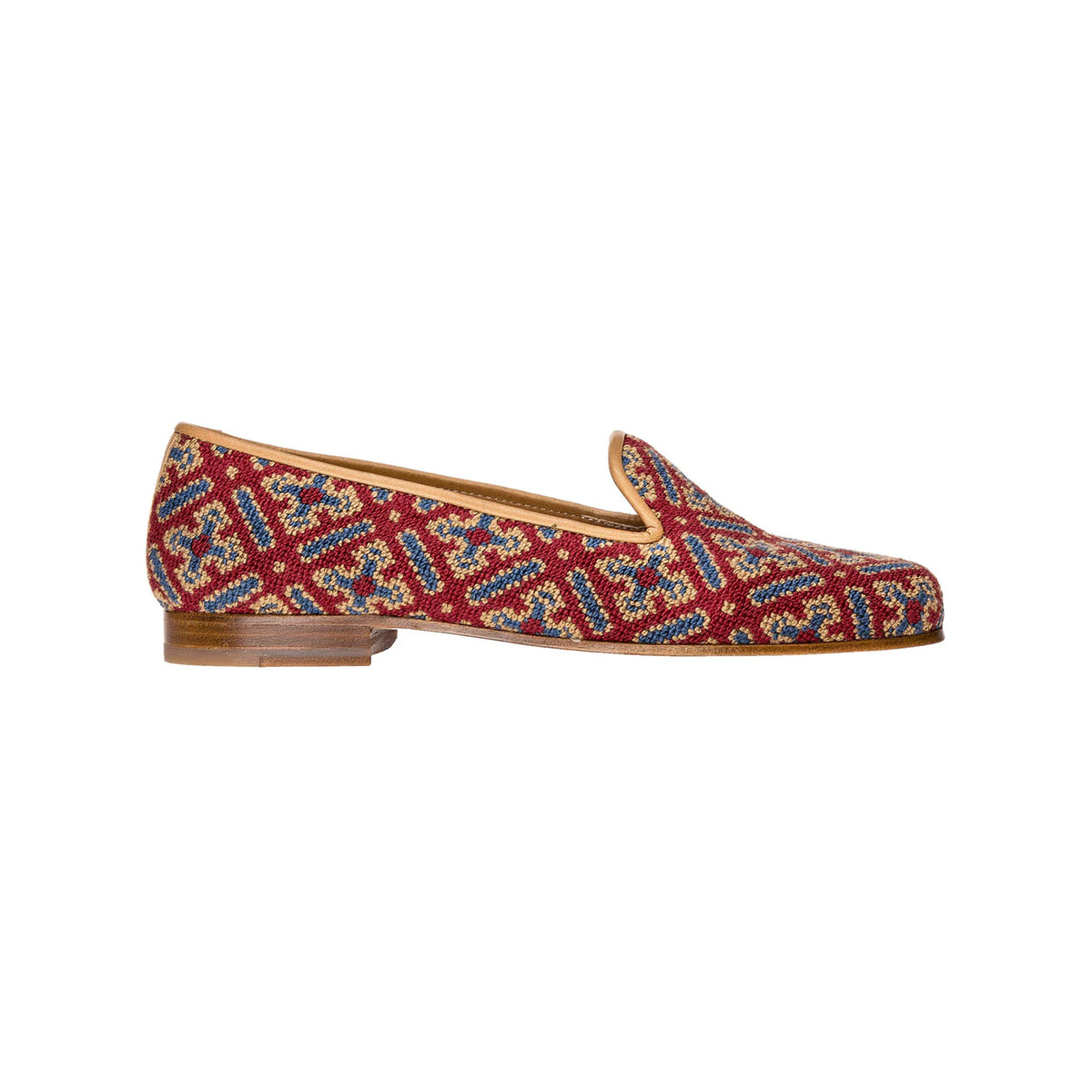 Side view of Men’s Cuenca Slipper in Red showcasing its intricate geometric pattern and stacked wooden heel against a white background