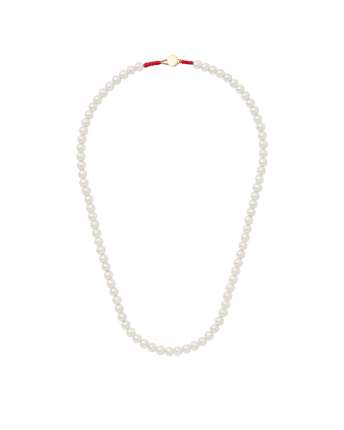 Flat-lay of The Charm Pearl Necklace showcasing glass pearl beads and gold button closure with red cord on white background