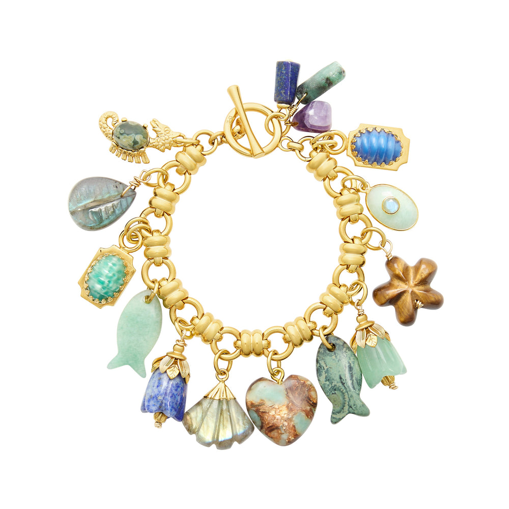 Top view of Mermaid Parade Bracelet with gold-plated chunky chain and semi-precious shell and fish charms on white