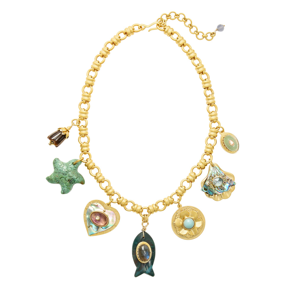 Flat lay of Mermaid Parade Necklace showcasing gold-plated chunky chain with assorted sea charms on white background