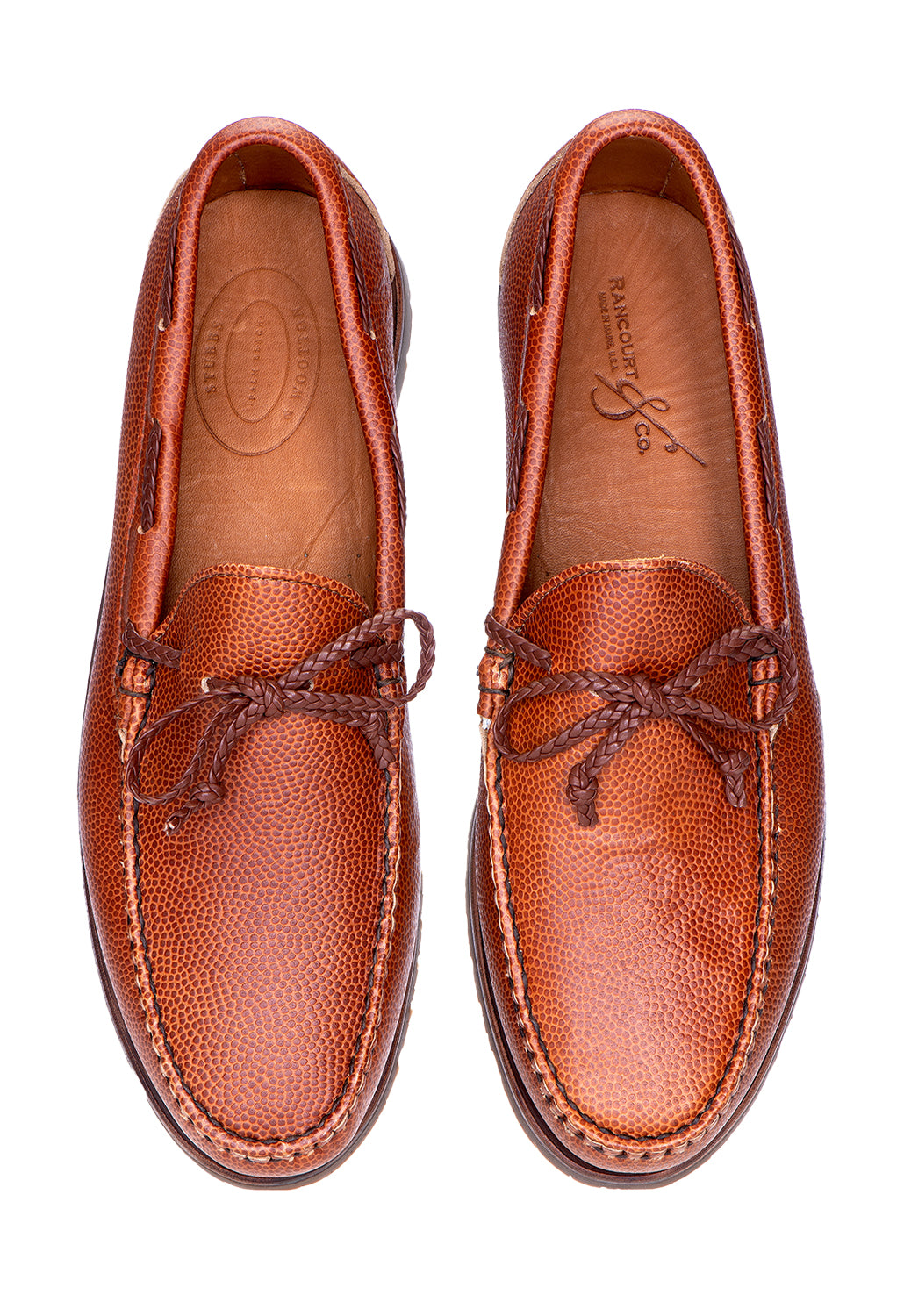 Top view of Men’s Merritt Football Boat Shoe in brown pebbled leather showcasing braided ties and moccasin stitching on white