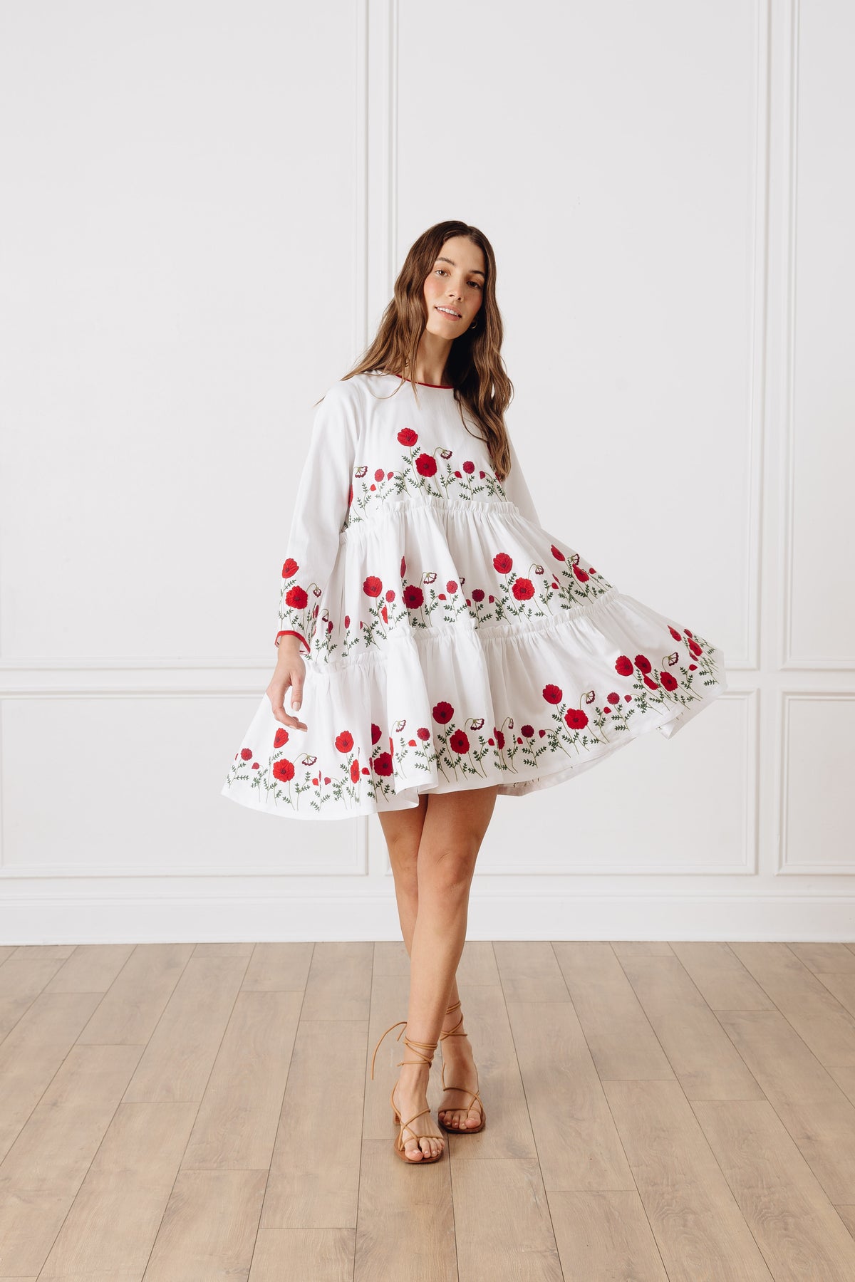 Front view of OTM Exclusive Lolita Short Dress showcasing red floral embroidery and tiered silhouette against a white paneled wall