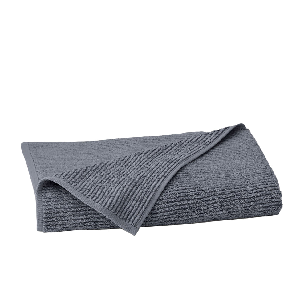 Folded Turkish ribbed bath sheet in mineral showing ribbed texture and turned-down corner on white background