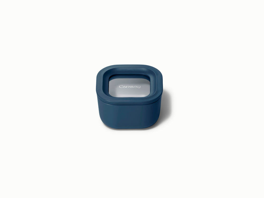 Front view of Mini Square Container in navy showing sealed lid with Caraway logo on white background