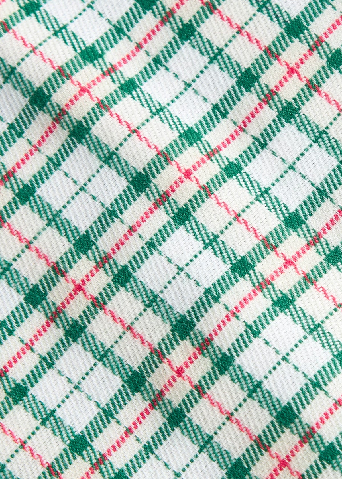 Little English traditional children's clothing. Green, red, and cream Mistletoe Tartan flannel fabric swatch