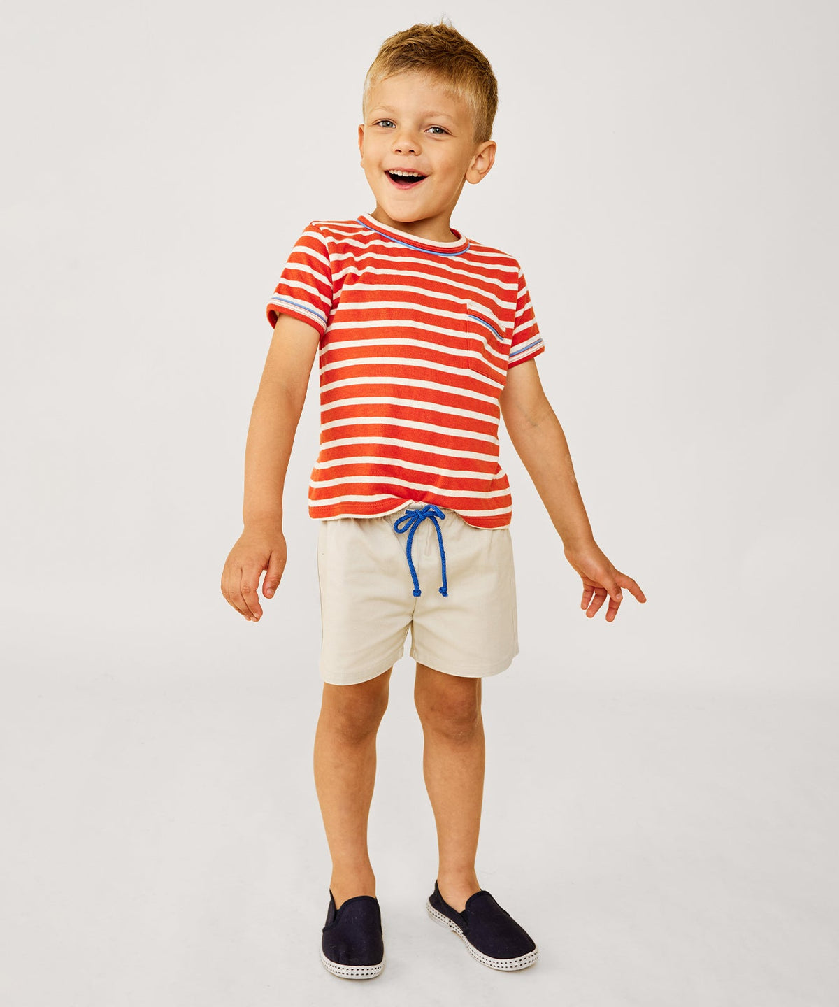 Front view of Bingo Short in Shell showcasing the blue contrast drawcord and shorter inseam on a child against a light background