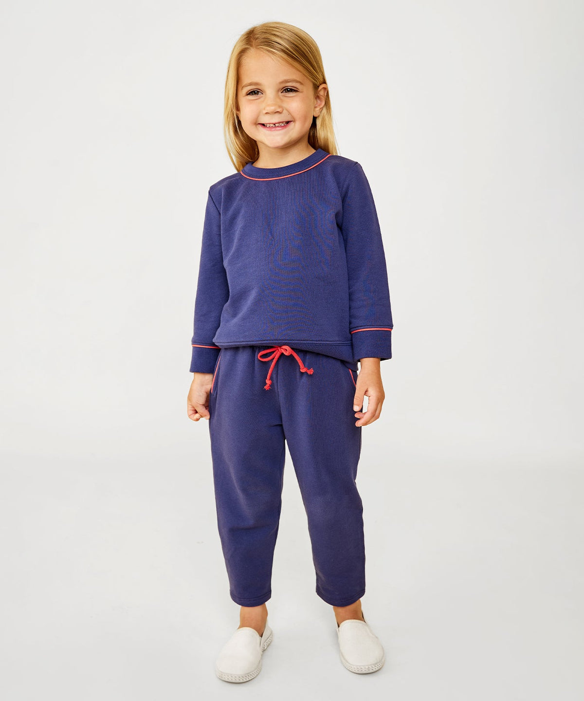 Front view of navy Chris Jogger worn by a child, showcasing a drawstring waist and cuffed ankles against a light background