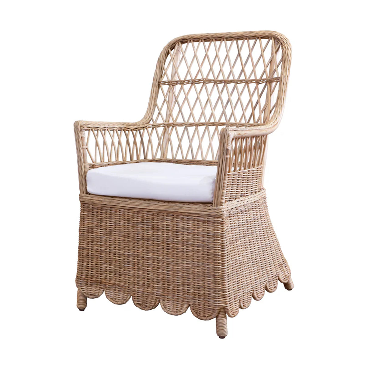 Three-quarter view of Monaco chair showing natural woven rattan, lattice back, scalloped skirt, and white cushion on a white background