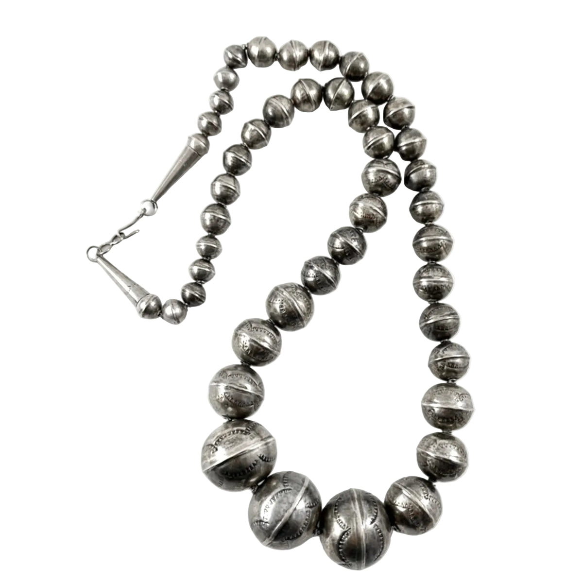 Front view of handmade stamped silver beads showcasing graduated sizes and stamped texture on a white background