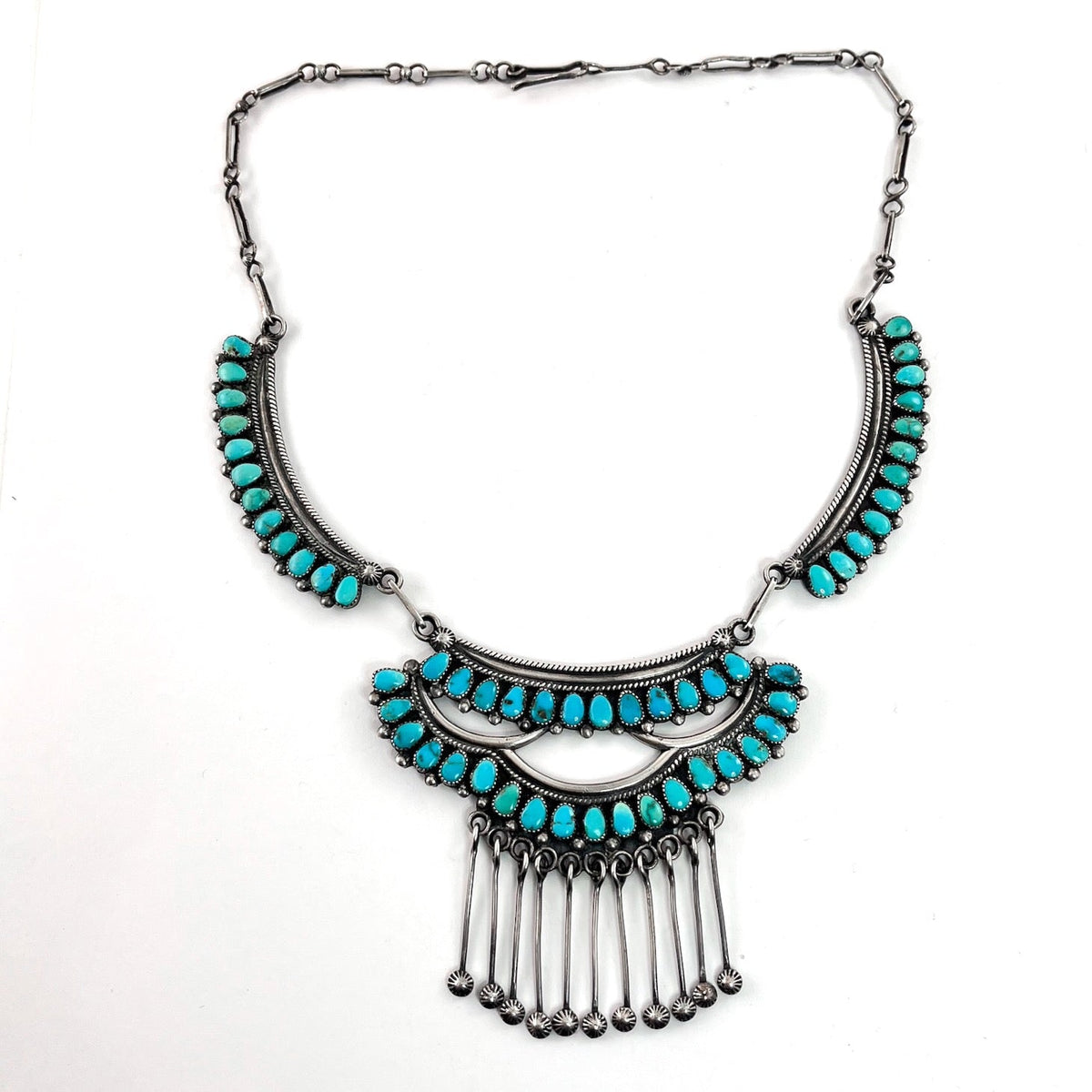 Front view of vintage three-panel necklace with turquoise panels, silver dangles, and handmade star studs