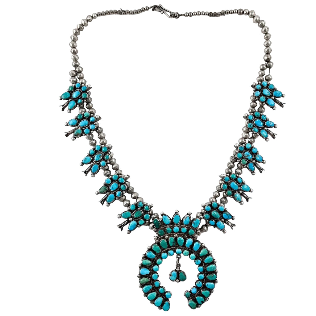 Front view of Vintage Turquoise Cluster Necklace with American turquoise clusters, circular pendant, and sterling silver