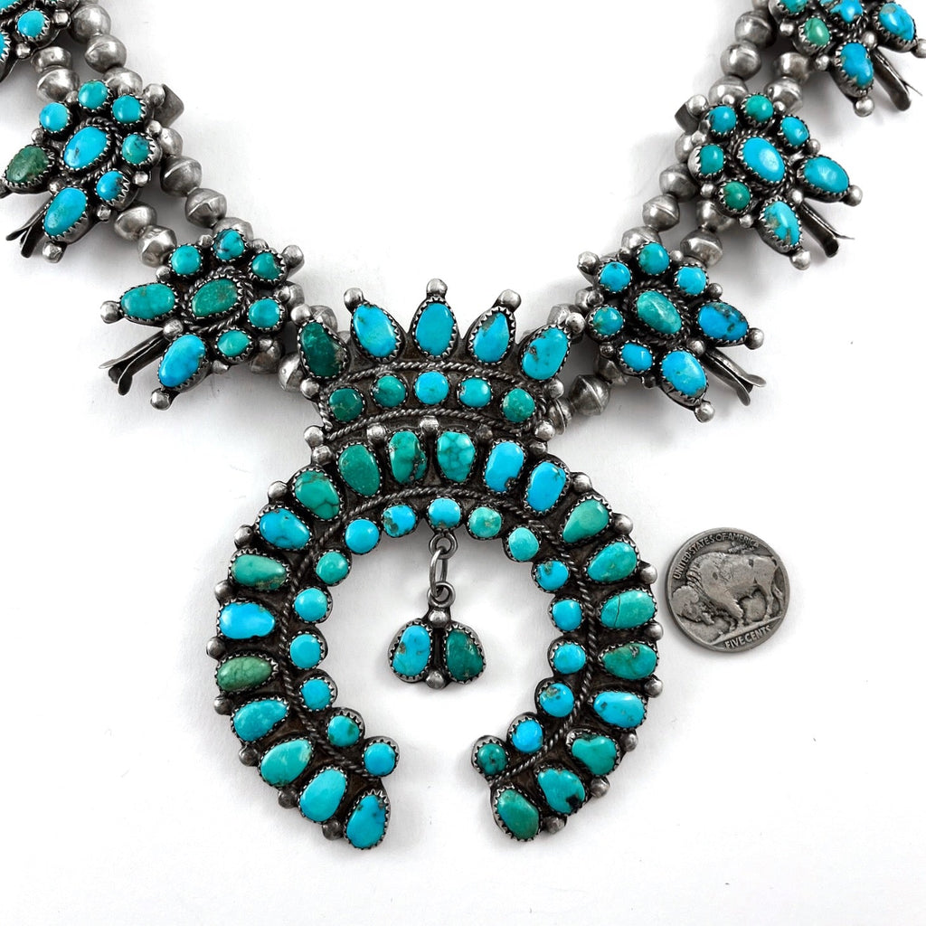 Front view of vintage turquoise cluster necklace showcasing American turquoise in sterling silver on a white background