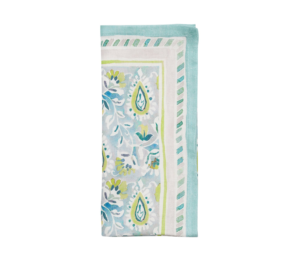 Folded Mira Napkin in Seafoam & Green showcasing hand-painted paisley and vine motifs on linen