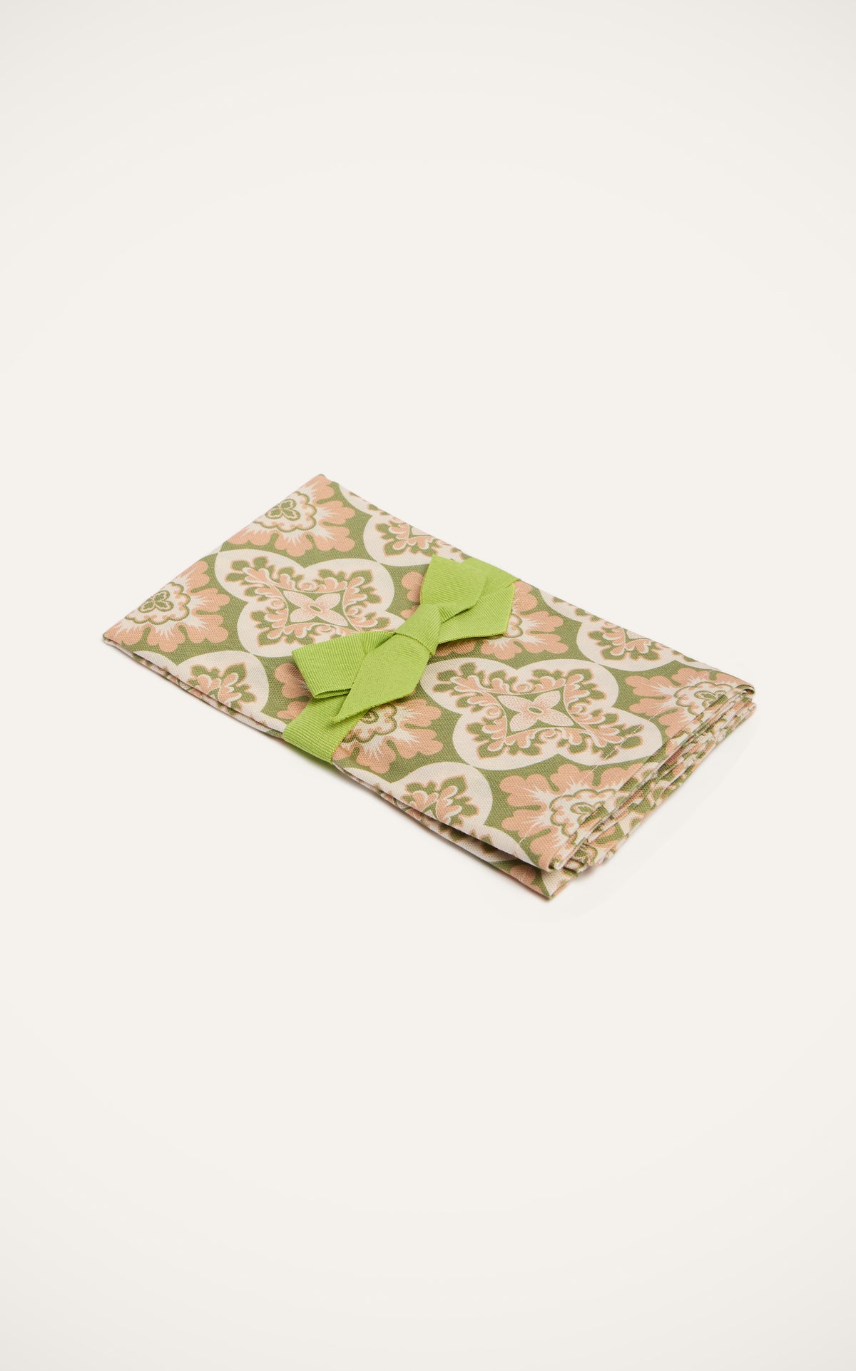 Angled view of Large Napkins in Palazzo Light Pink, Set of 2 showcasing floral Palazzo print and green ribbon
