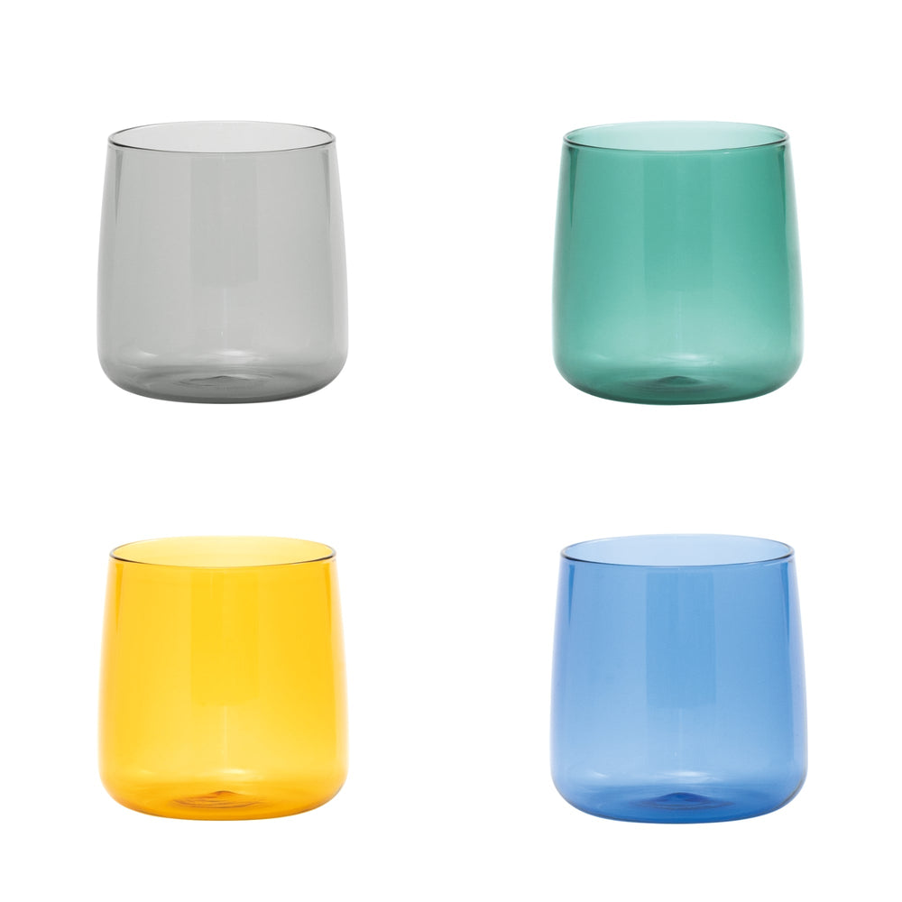Front view of No Bilia Tumbler set of 4 showing four colored glass tumblers (smoke gray, teal, golden yellow, blue) on white background