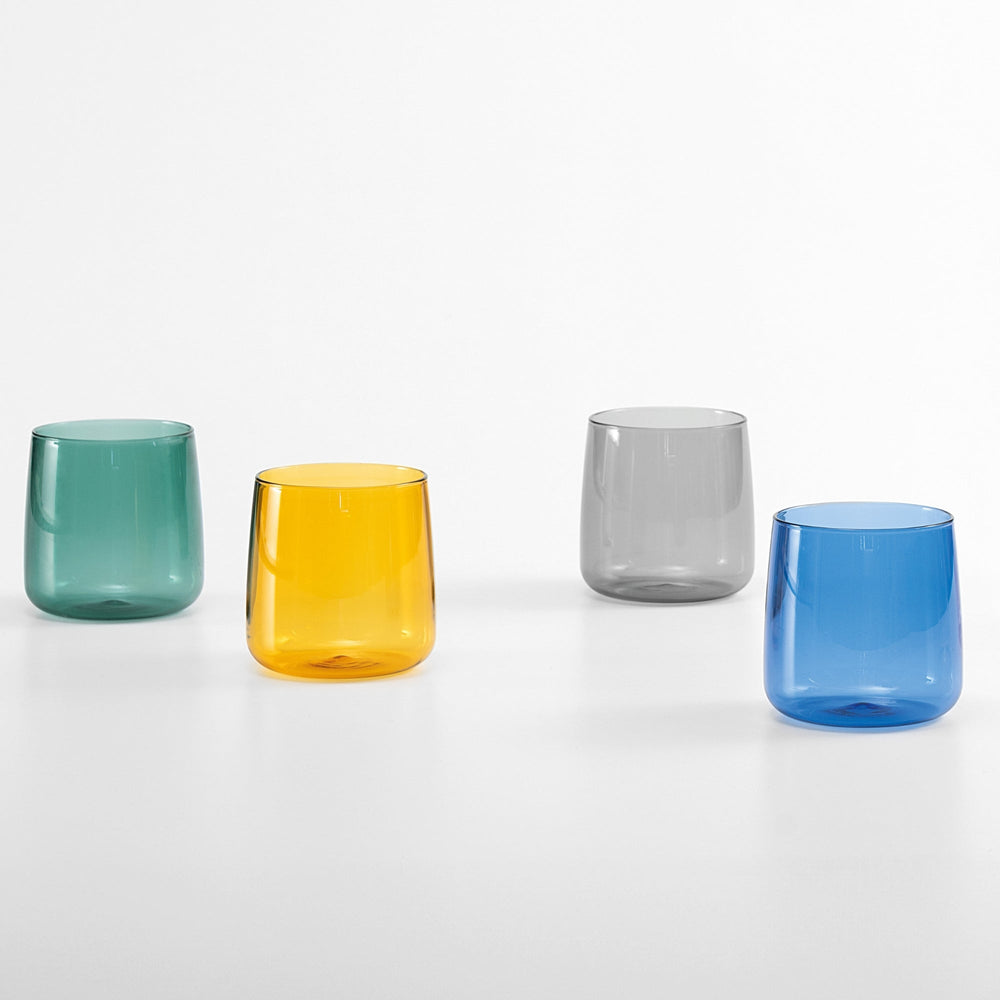 Front view of No Bilia tumbler set of 4 showing translucent green, yellow, gray, and blue glasses on white background