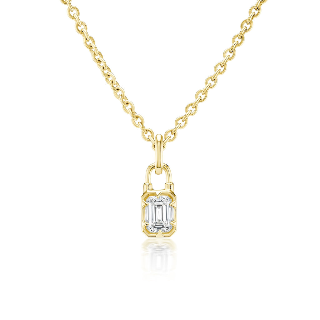 The Collet Set Locket Motif Diamond Pendant Necklace features a rectangular emerald-cut diamond in a sleek modern gold bezel, crafted in your choice of yellow or white gold for a contemporary look.