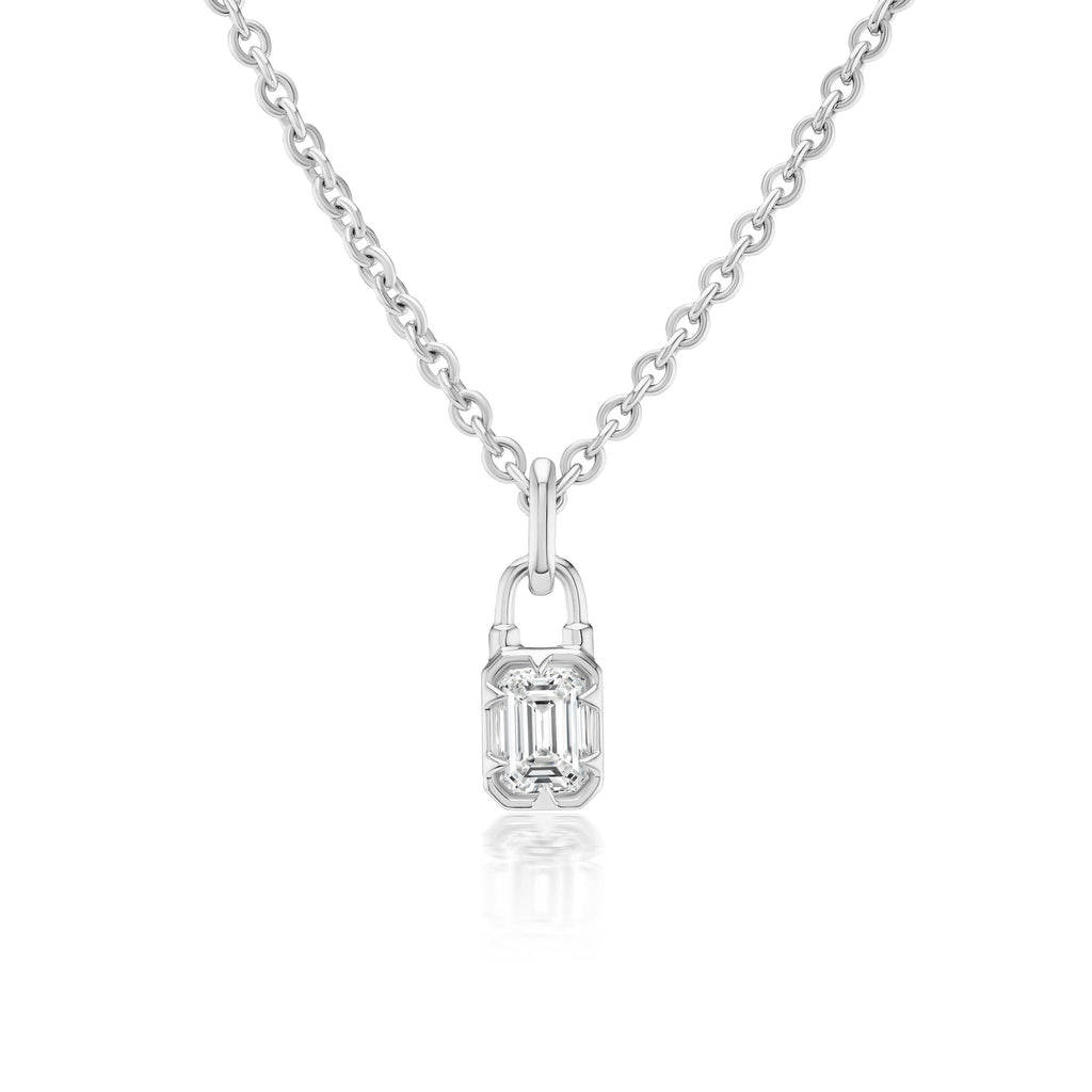 The Collet Set Locket Motif Diamond Pendant Necklace is a silver chain with a padlock-shaped pendant featuring an emerald-cut diamond at its center.