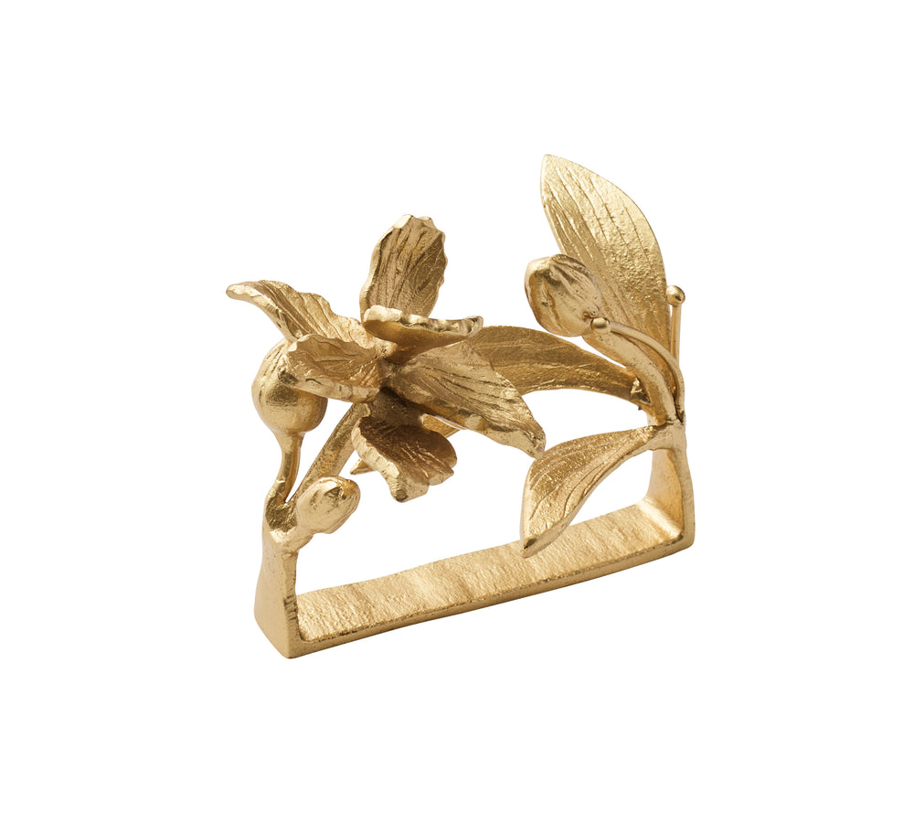 Three quarter view of gold orchid napkin ring showcasing sculpted orchid flower and textured leaves on white background