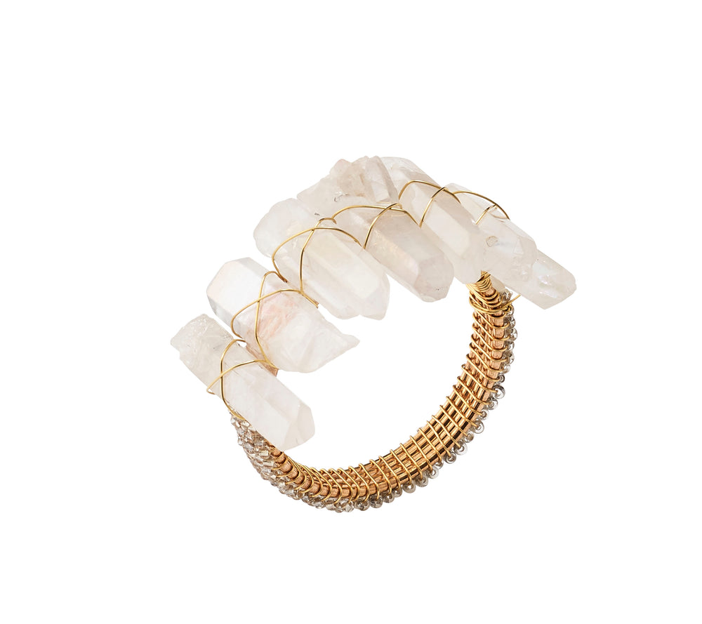 Angled view of Radiant Napkin Ring in Iridescent, Set of 4 showcasing staggered rock crystals, metal, and glass beads on white