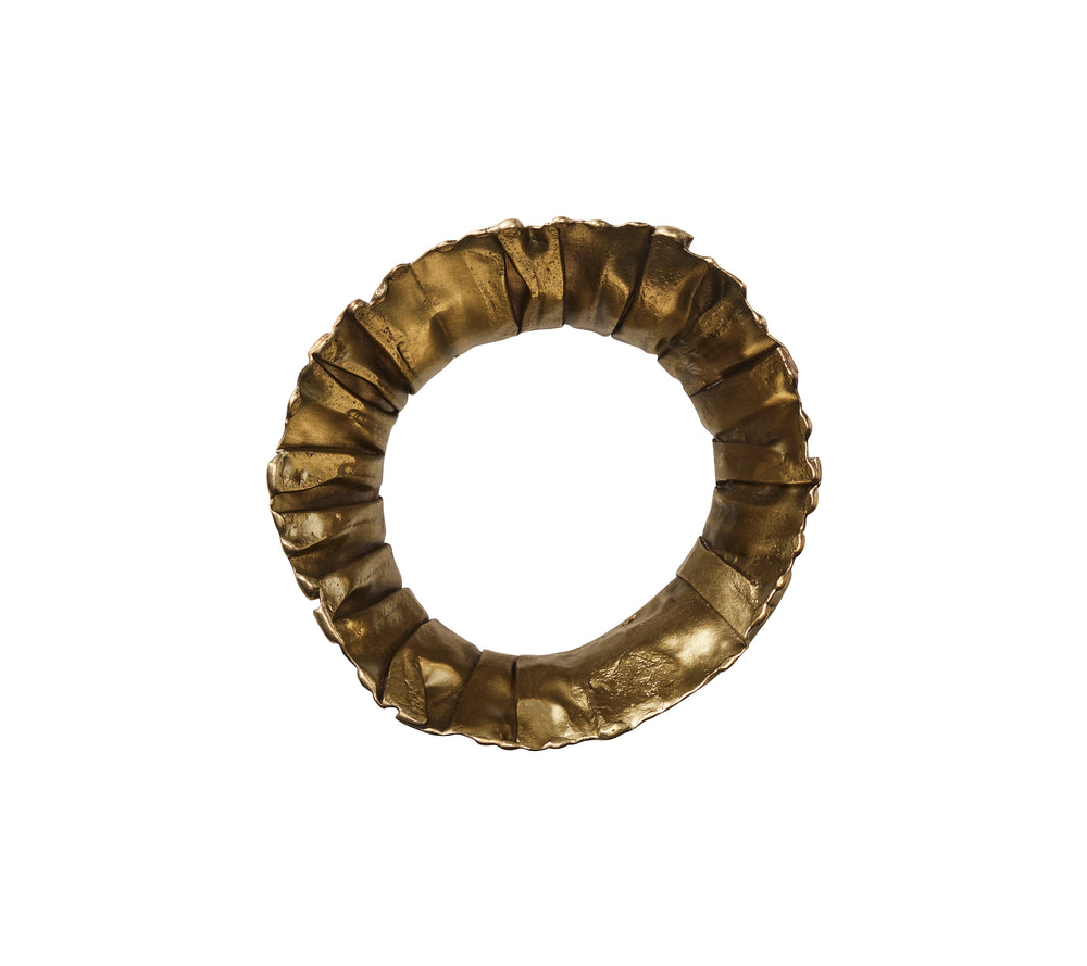 Top view of clinched napkin ring (single from set of 4) showing sculptural ruffled gold-brass finish on white background