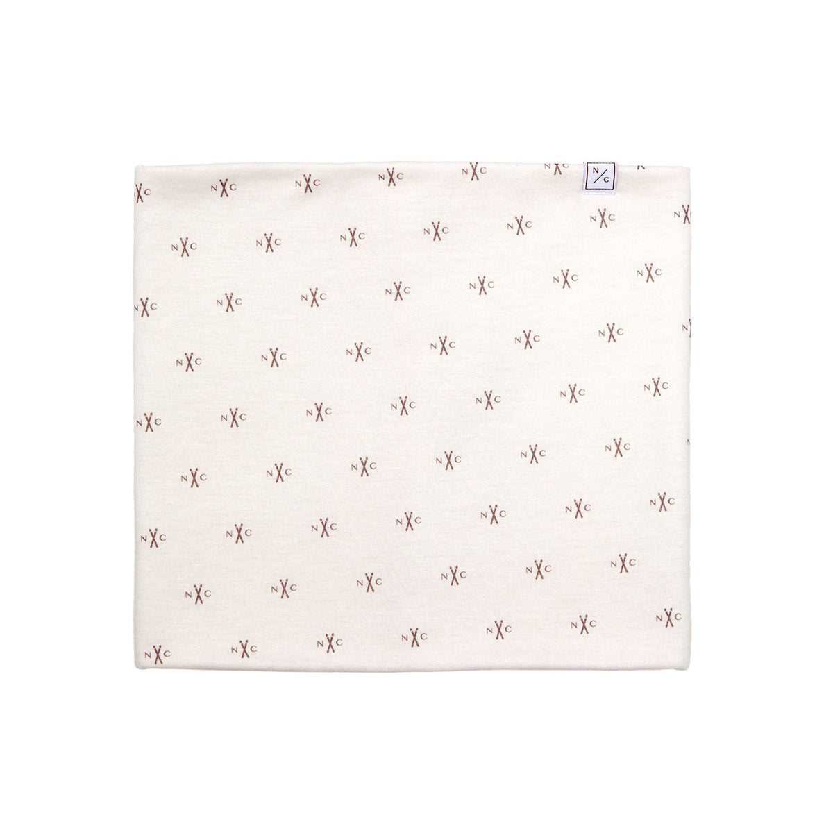 Flat lay of NC Skis fleece-lined neck warmer showing all-over small brown N/C ski logo print on pale pink fabric