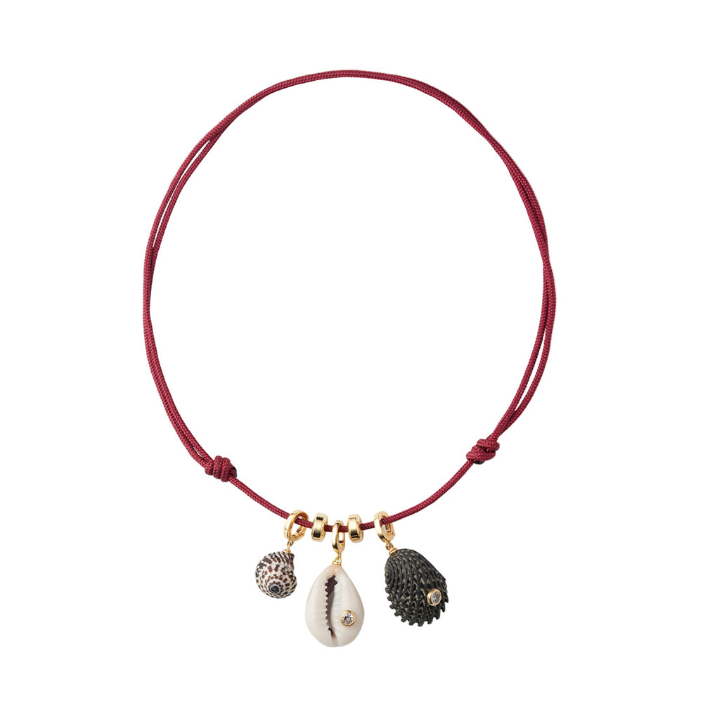 Front view of Drift Necklace with three natural shell charms, cubic zirconia accents, gold-plated rondelles on red paracord