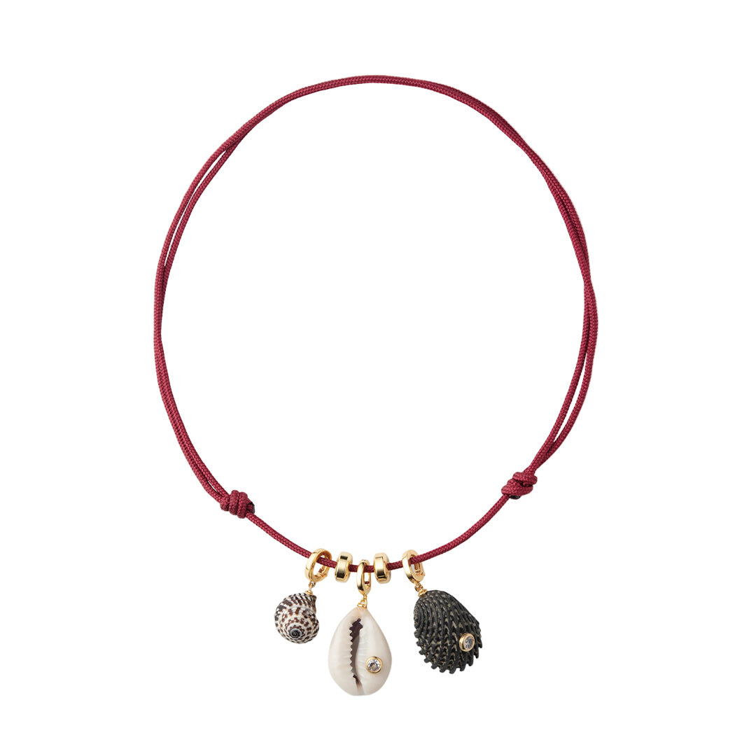 Front view of Drift Necklace with three natural shell charms, cubic zirconia accents, gold-plated rondelles on red paracord