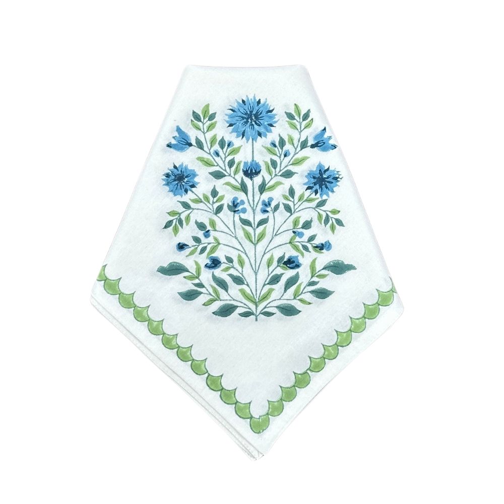 Hand block printed napkin with french country blue floral design on a white background with scalloped border