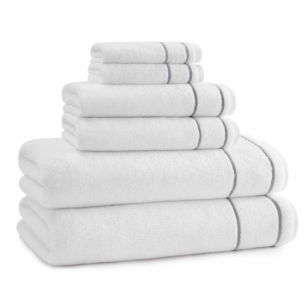Front view of Newbury washcloth stacked with matching towels showcasing gray embroidered trim on white background