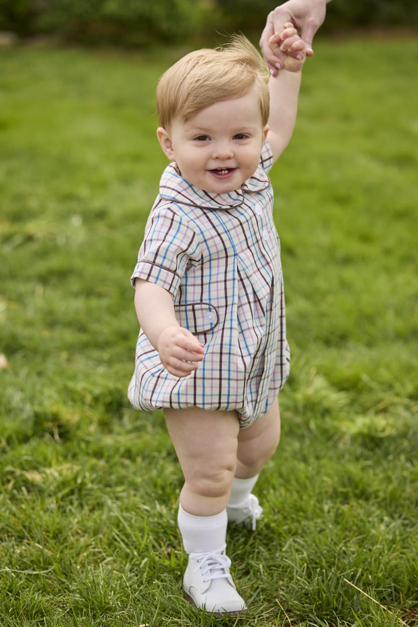 Little English traditional children's clothing.  Short sleeve peter pan bubble in brown, blue, and pink Wilmington Plaid for baby boys with button tabs and corduroy piping.