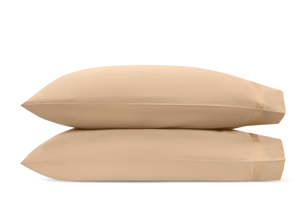 Side view of Nocturne pillowcase pair showcasing Ambrosia beige color and banded cuff on white background