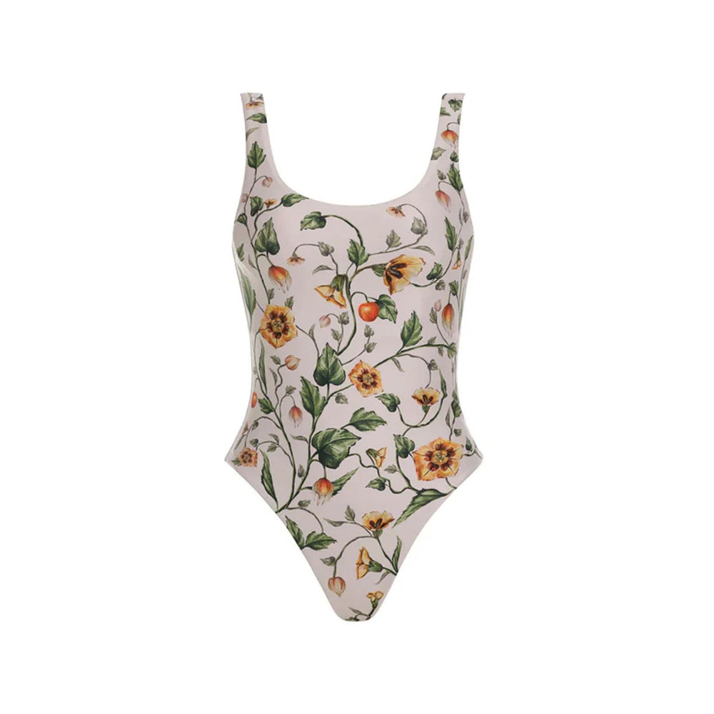 Front view of Gema one-piece swimsuit showing scoop neckline, high-cut leg, and Uchuva botanical print on pale pink background