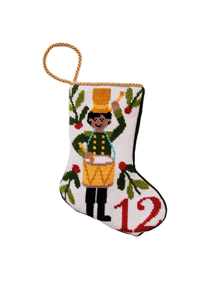 Front view of bauble stocking with hand-stitched needlepoint drummer, red 12 and gold hanging loop on white background