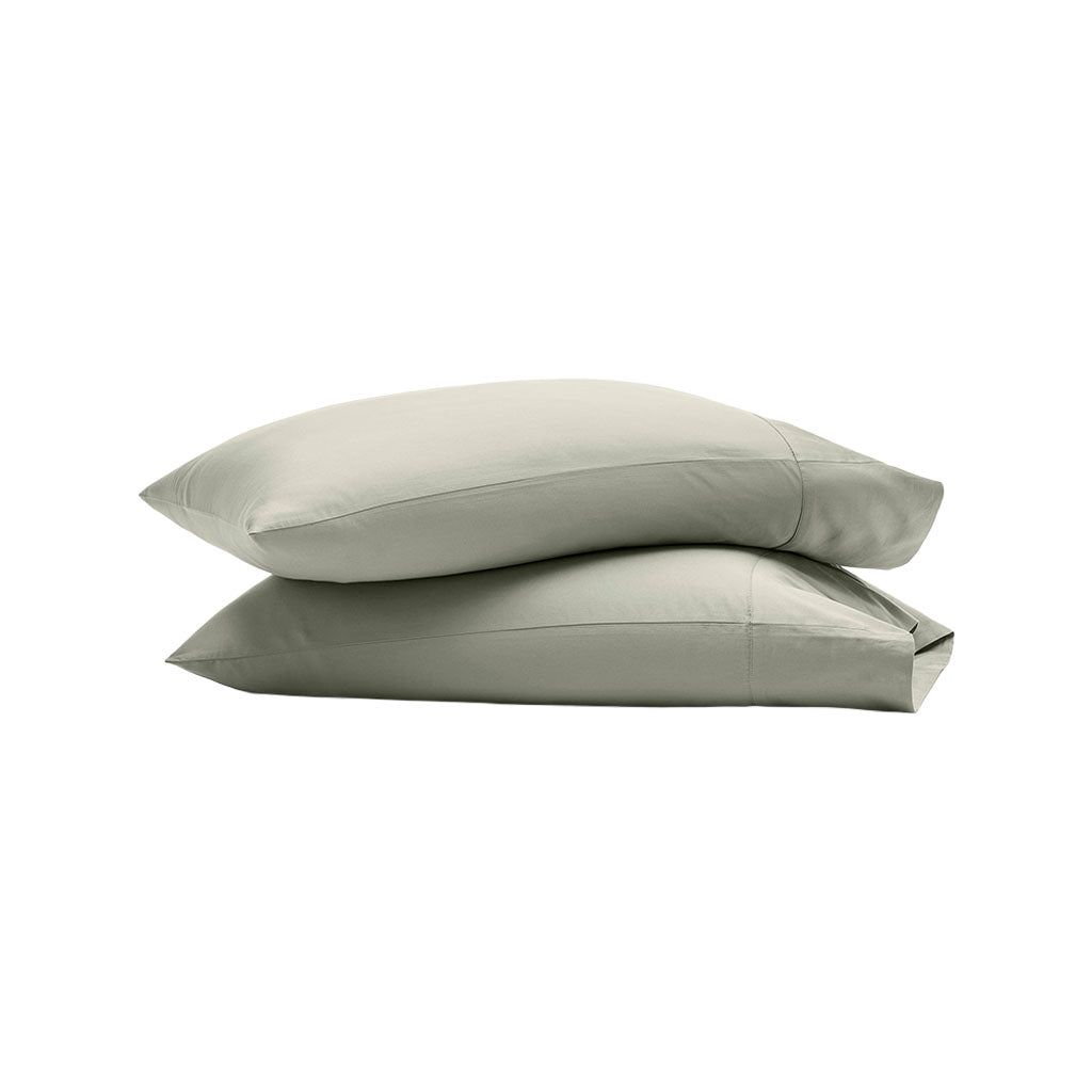 Side view of Percale Hemmed Pillowcase Set in Sageleaf showcasing stacked pillowcases and 7 inch hemline with a white background