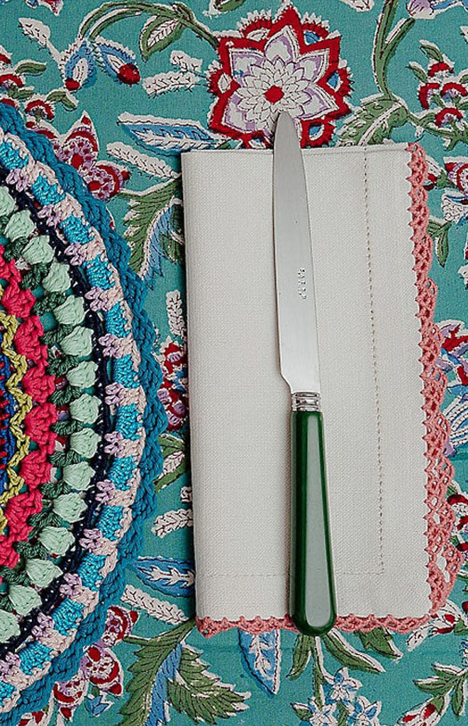 Close-up of Beatrice Napkins in White and Pink, Set of 2 showcasing red scalloped embroidery border on patterned table linen