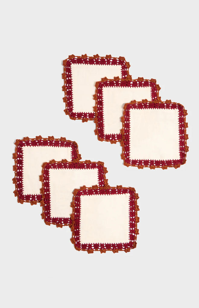 Overhead view of Crochet Embellished Cocktail Napkins, Set of 6 with trio of rich-toned crocheted edging