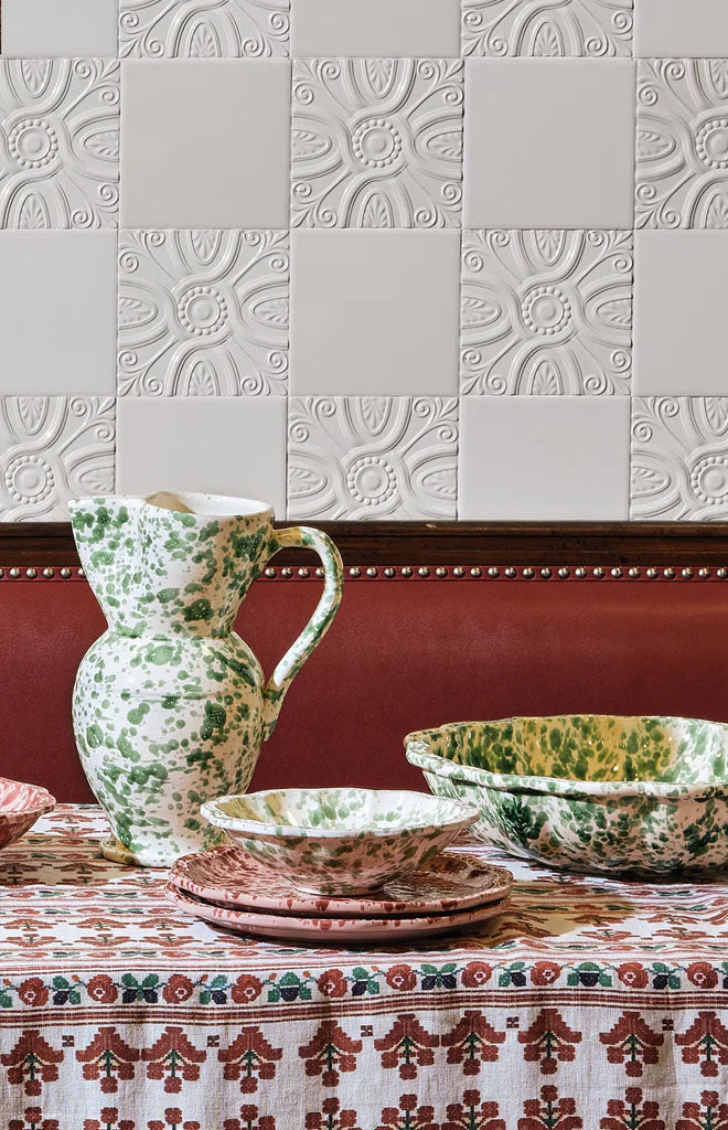 Front view of Speckled Pitcher in Green and White showcasing hand-painted green-and-white speckles with patterned tableware