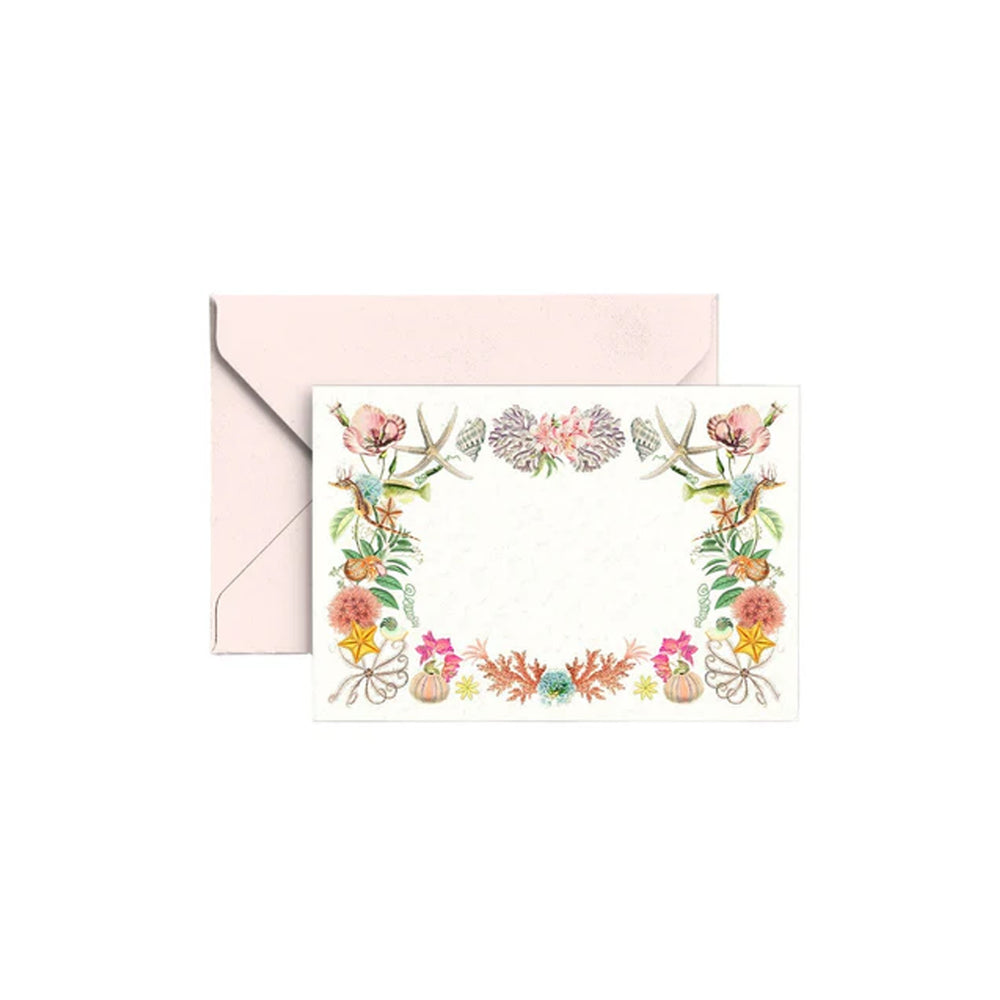 Front view of Marea gift enclosure card showcasing coastal floral and shell border with matching blush envelope