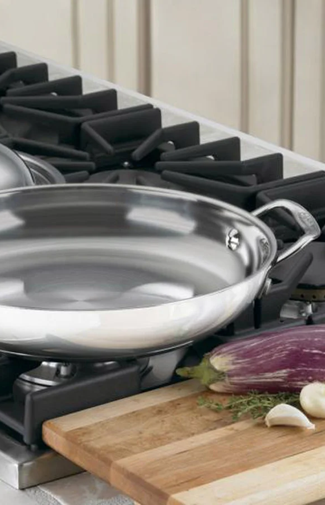 Close-up of Chef’s Classic 12-inch Everyday Pan showcasing polished stainless steel on a gas stovetop