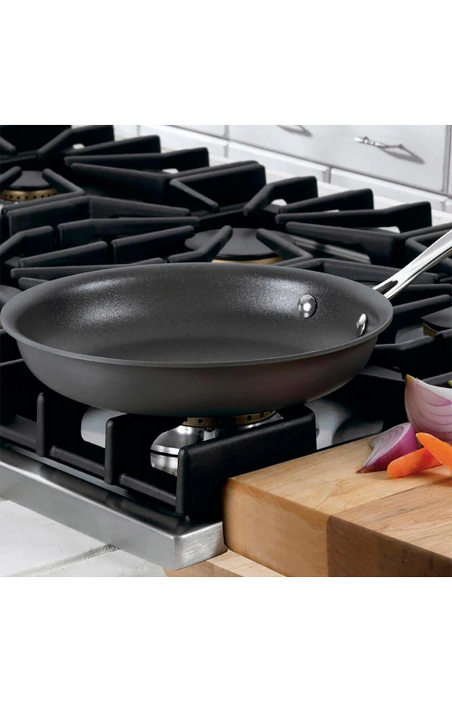 Front view of Chef’s Classic Non-Stick Hard Anodized Skillet showcasing its nonstick interior on a stovetop