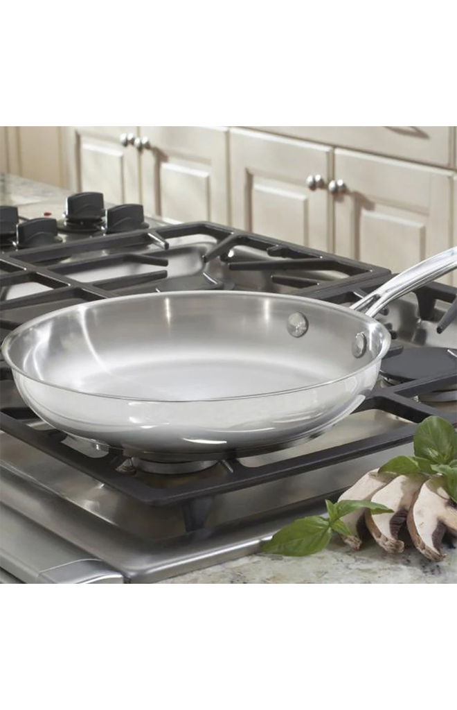 Angled view of Chef’s Classic 10-inch Stainless Skillet showcasing its stainless steel interior on a gas stovetop
