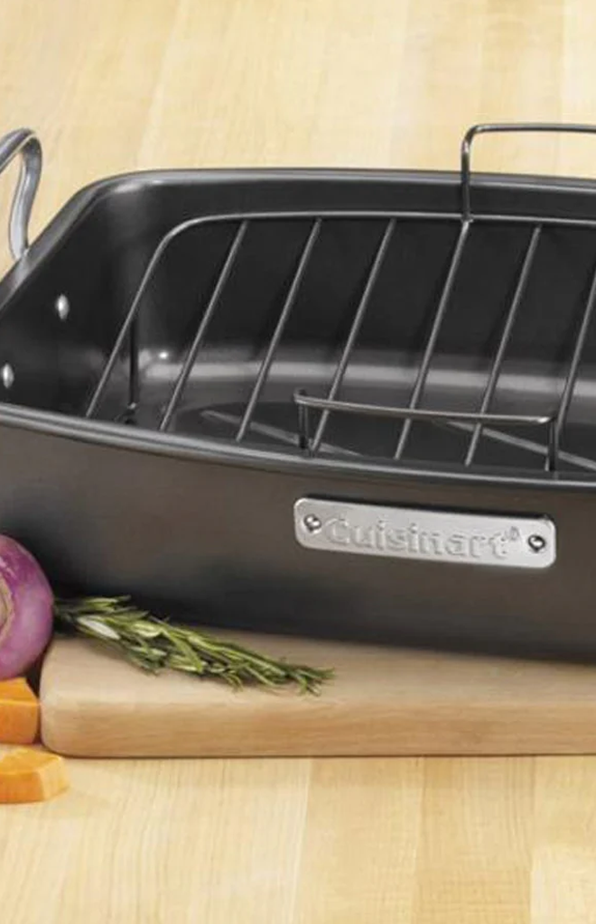 Close-up view of black 17 by 13 inch nonstick roaster showcasing its removable V-rack with a wooden cutting board background