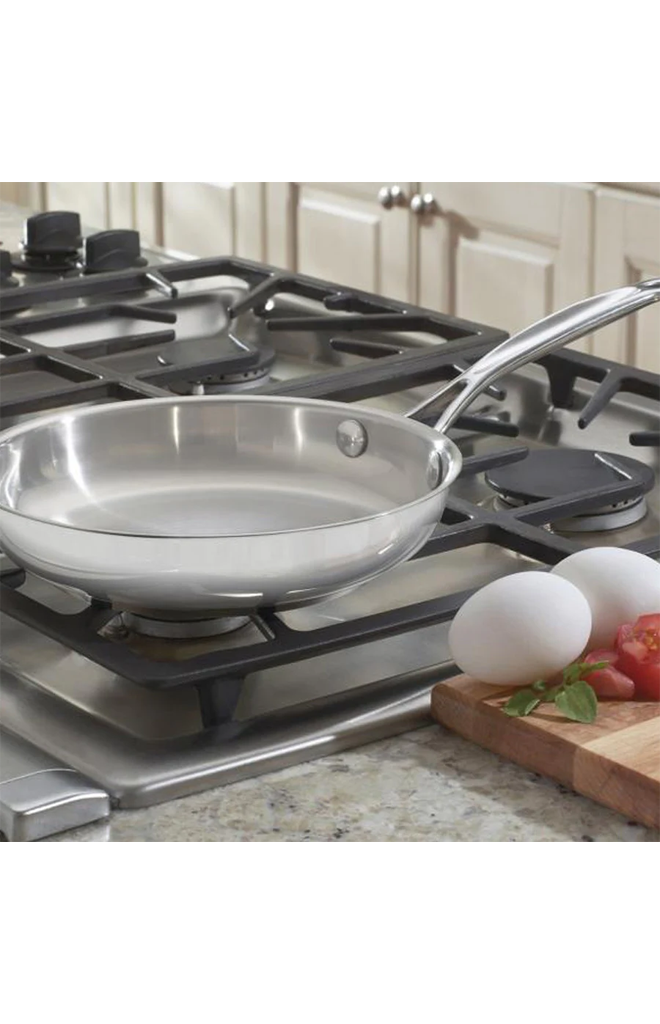 Angled view of Chef’s Classic Stainless 8-inch Skillet showcasing mirror finish and helper handle on a gas stovetop
