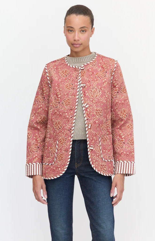 Front view of The Rowan Jacket in Autumn Floral showing quilted cotton, striped trim, patch pockets, and boxy fit on white