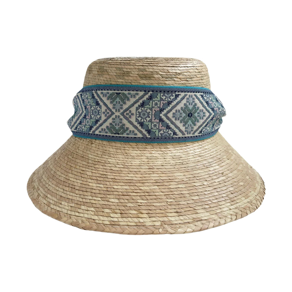 Front view of Clematis bucket hat showcasing woven palm straw and vintage blue tapestry ribbon band on white background